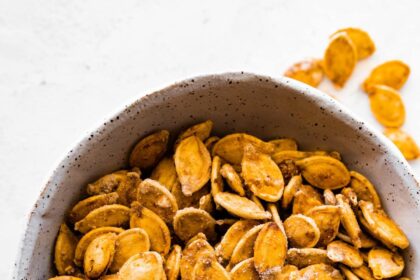 A bowl of roasted and salted pumpkin seeds.