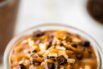 One glass jar filled with samoas overnight oats. It